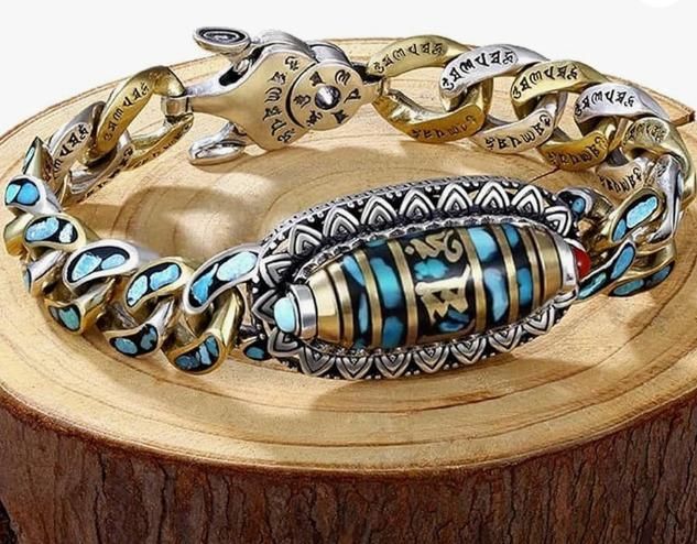 Six-Character Mantra Nine-Eyed Dzi Bead Bracelet with intricate designs and vibrant turquoise accents