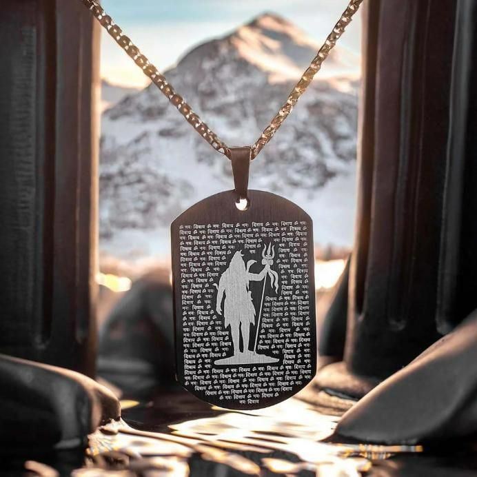 108 Om Namah Shivay pendant on a chain with intricate detailing against a mountain backdrop