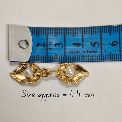 Gold pearl frog buttons close-up pearl and metal hook detail – Gleemify