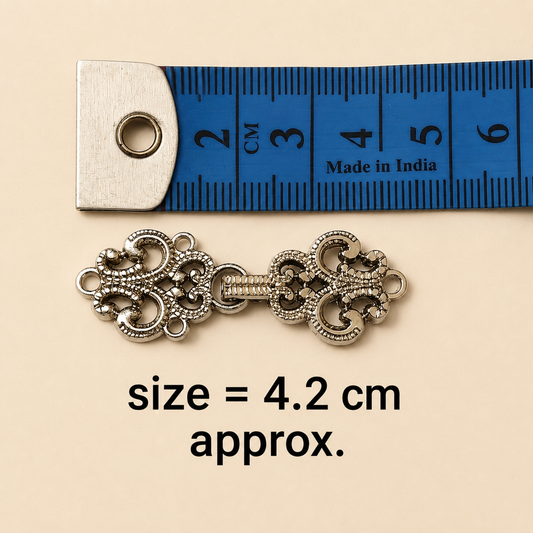Silver frog closure buttons close-up metal hook detail India – Gleemify