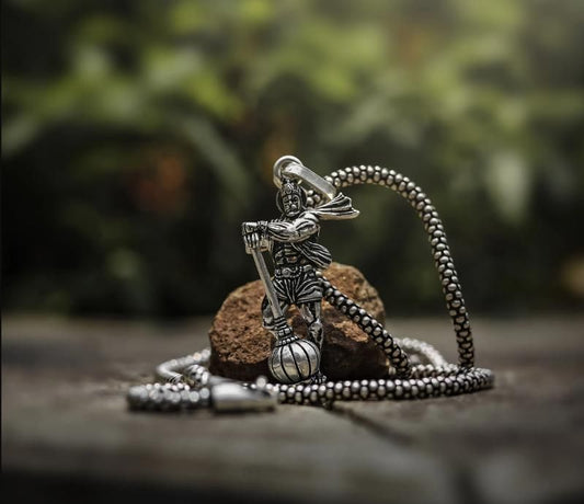 Hanumanji pendant with gada on a silver chain set against a natural background