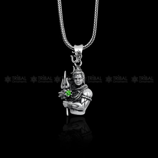 Spiritual Shiva locket in silver featuring a detailed Shiva figure holding a trident with a green gem